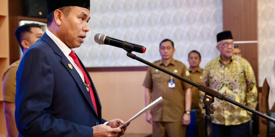 Plh. Asisten Administrasi Umum Sekda Aceh, Abd. Qahar, S.Kom, MM, atas nama Gubernur Aceh, melakukan Pengambilan Sumpah Jabatan dan Pelantikan dalam Jabatan Fungsional pada Pemerintah Aceh, di Aula Kantor BKA, Banda Aceh, Selasa, (31/12/2024).
