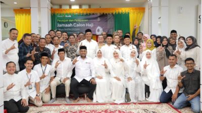 Direktur Utama Bank Aceh, Fadhil Ilyas (tengah), berfoto bersama jamaah calon haji dalam acara Peusijuk dan pelepasan 1.624 tamu Allah di Kantor Pusat Bank Aceh, Senin (21/4/2026). Selain memfasilitasi perbankan, Bank Aceh turut menjaga tradisi dan nilai spiritual nasabahnya melalui pendampingan yang menyentuh hati.